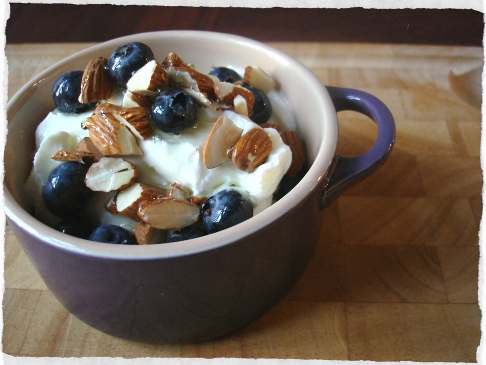 mint syrup over greek yogurt with blueberries