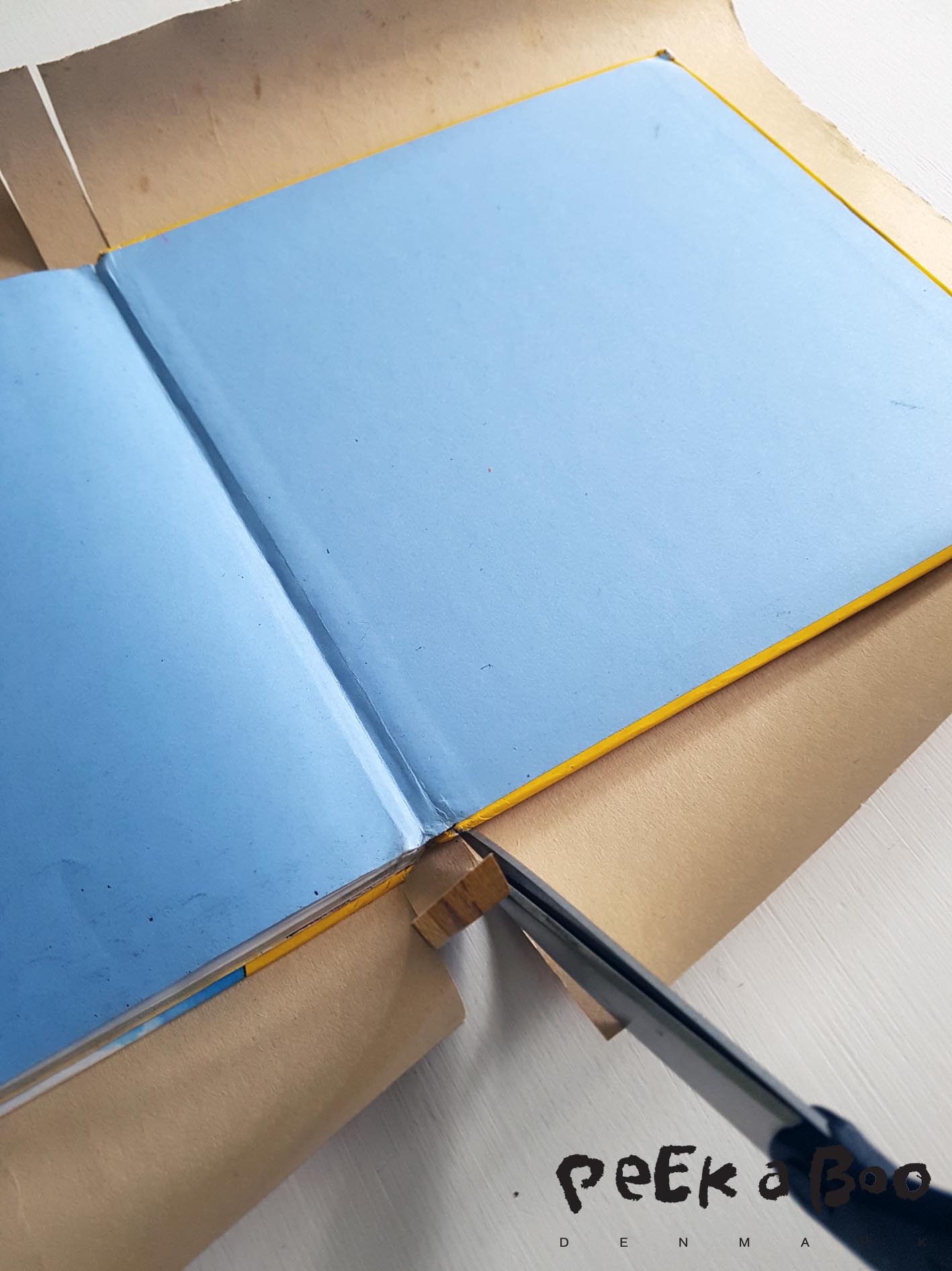 Place the book in the middle and cut slits by the back. Same width as the back of your book.