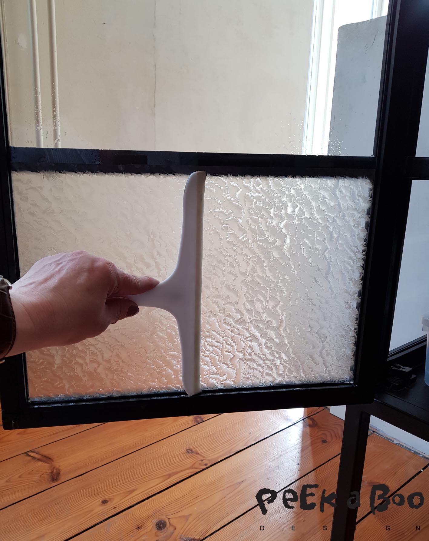 Ensure that there is no water between the glass and the film, by using the window scraper.
