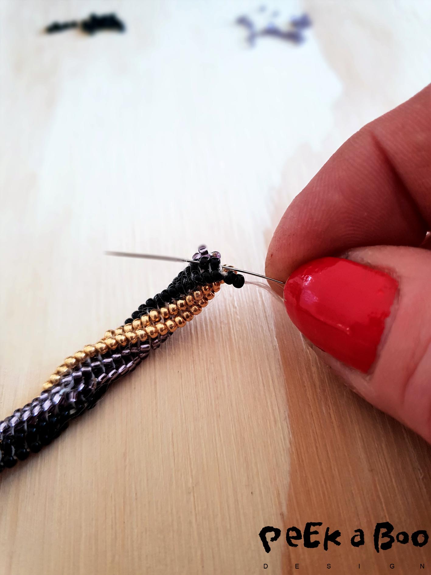 beadworking on the tubelar twisted bracelet. Here is the black colour colour 1...the one that I go two up and two down.