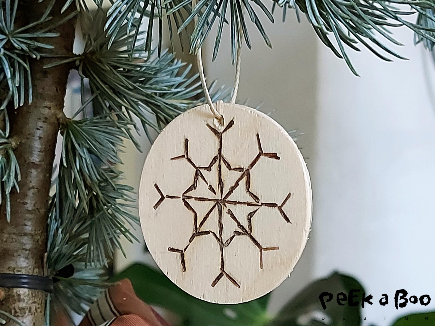 The round ornaments made with burned in snowflake pattern. 