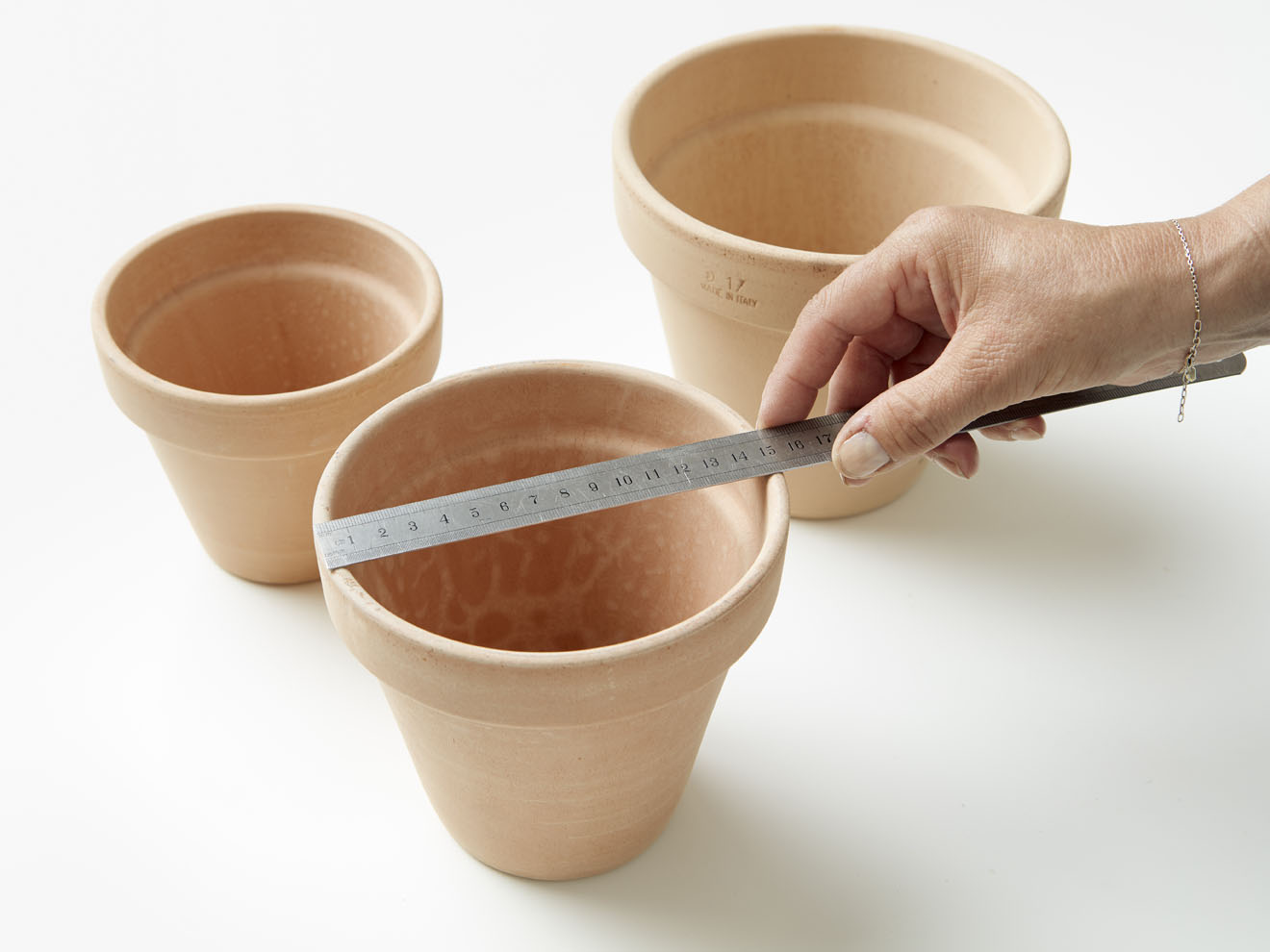 measure your flower pots to make the right size holes in your shelves.
