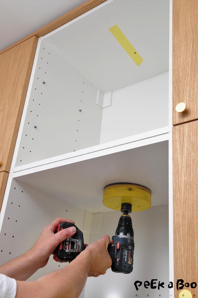 Drill the hole from bottom and through the lower cabinet.