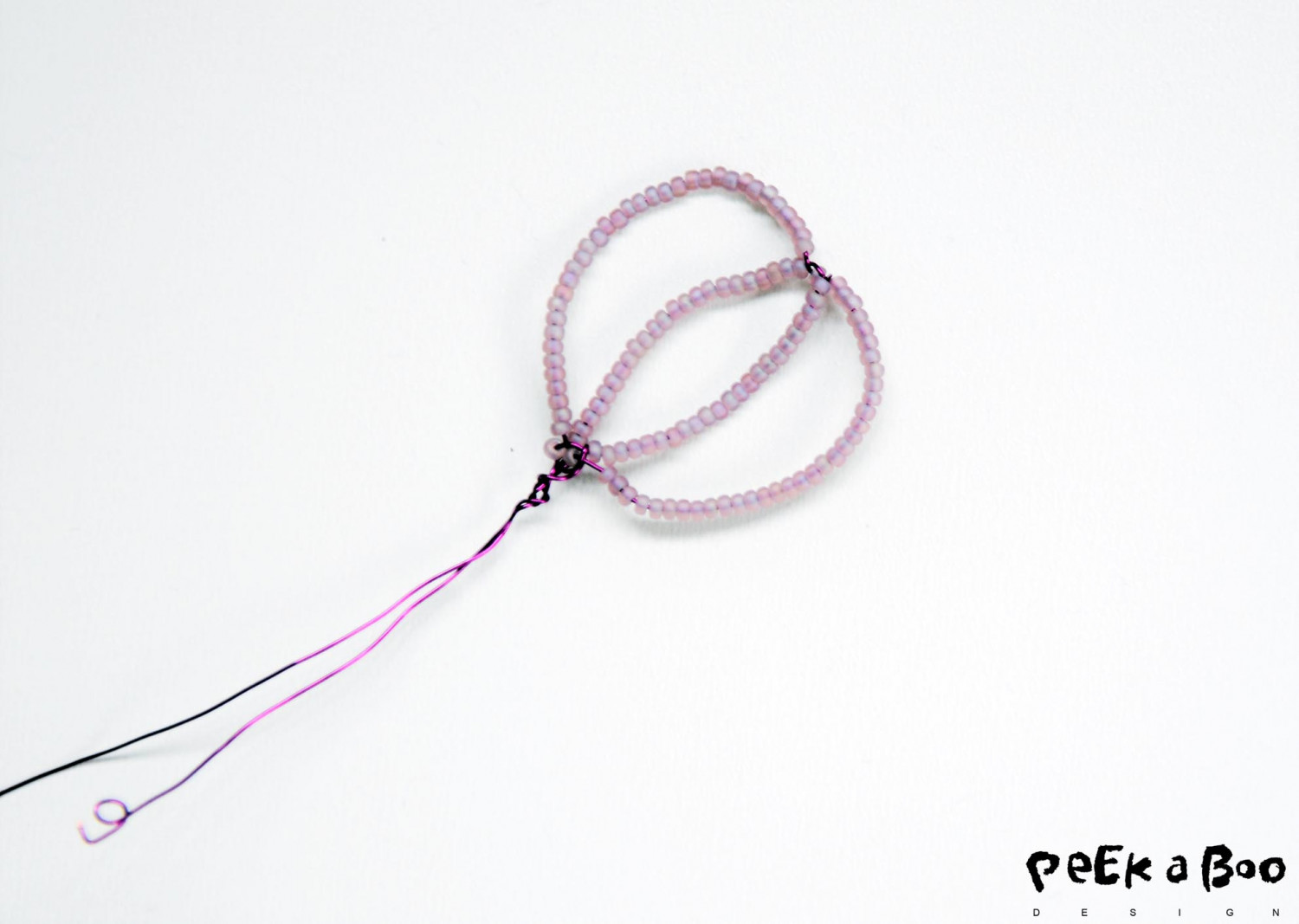 Now you add more wire with beads in the middle of the petal.