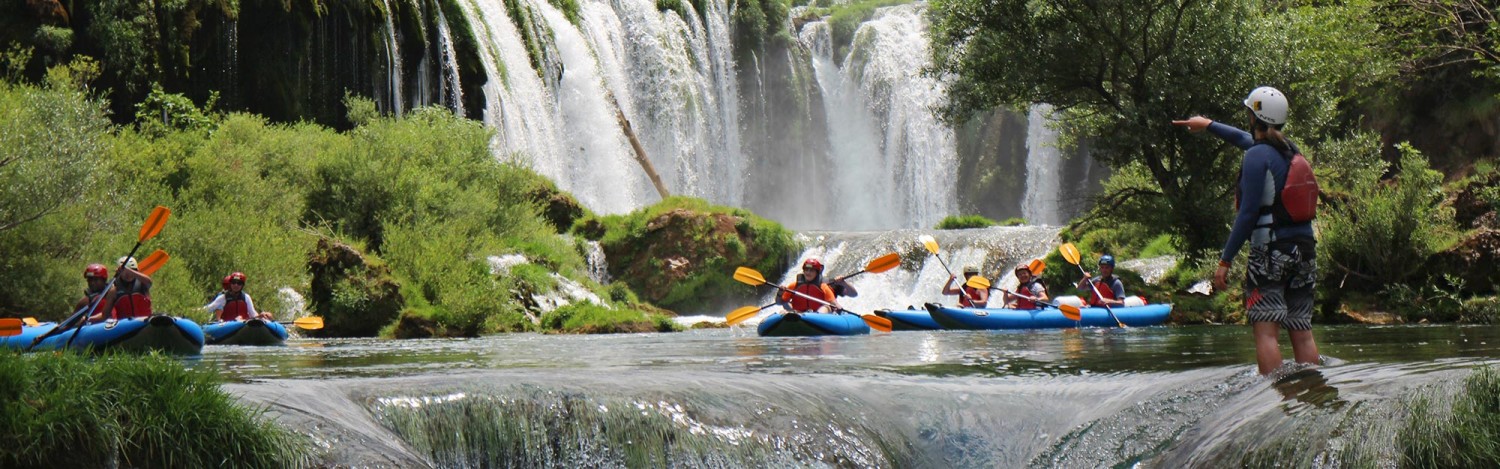 people-paddling-below-high-waterfall-on-zrmanja-river-1
