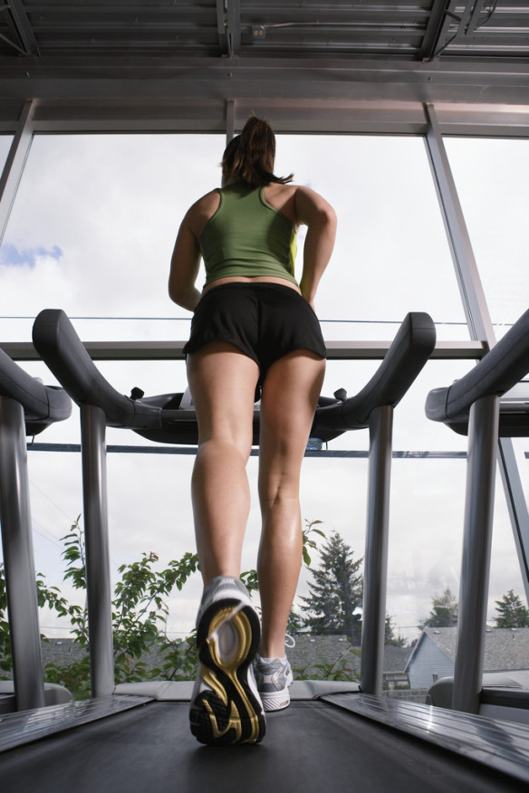 Young Woman Jogging on Treadmill --- Image by © Royalty-Free/Corbis