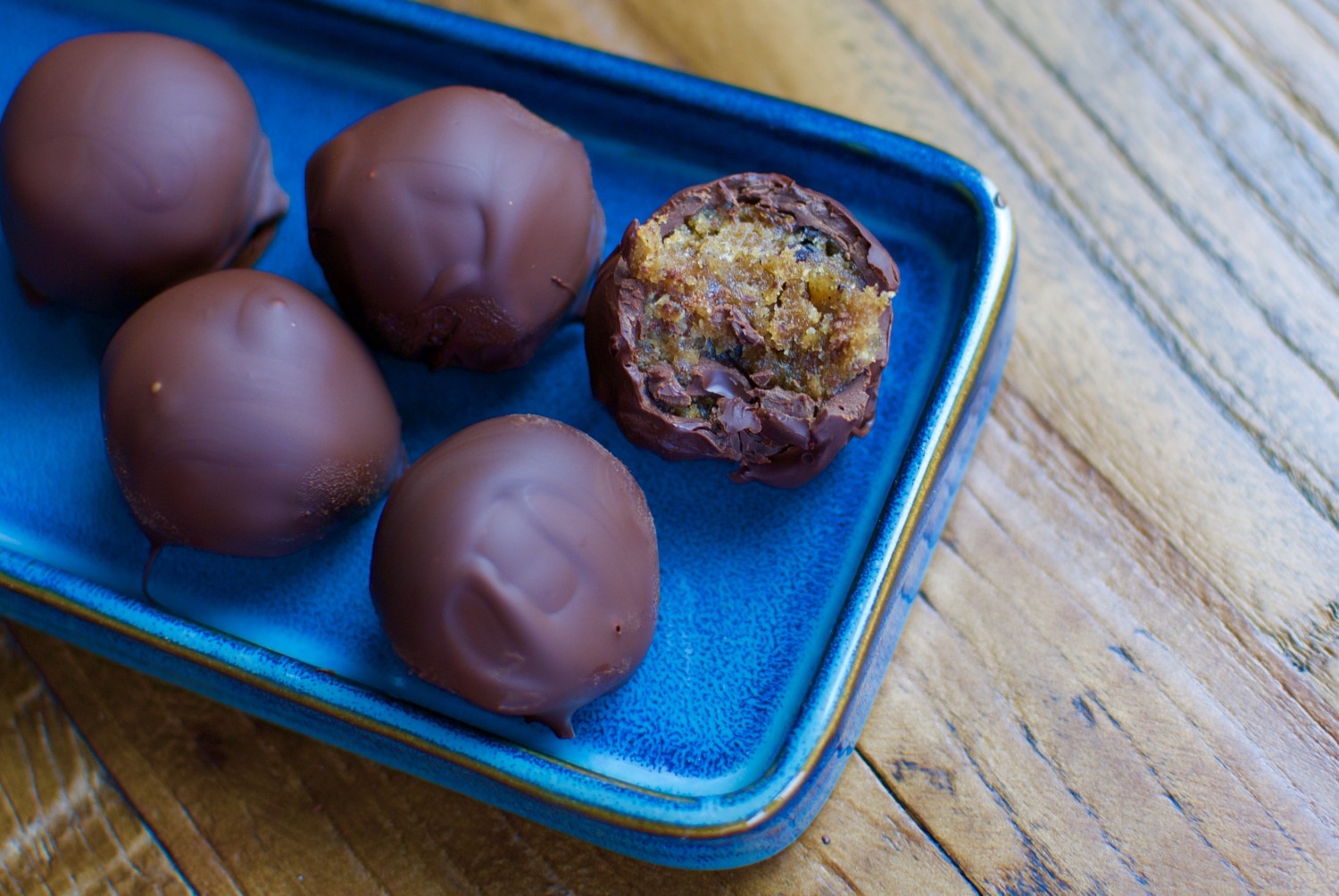 Chocolate covered date caramel bites with peanut butter